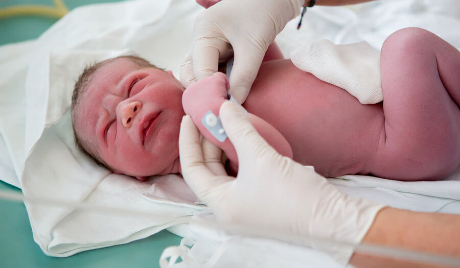 nurse midwive checking a newborn