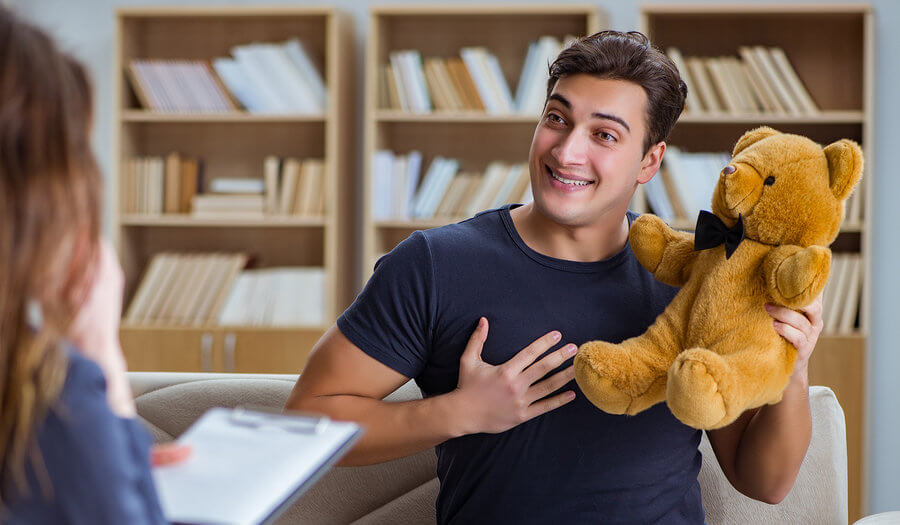 young man holding a teddy bear